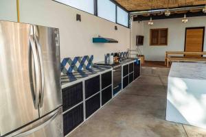 a large kitchen with a stainless steel refrigerator at Casa Cecilia Lodging House in Oaxaca City