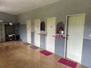 a row of lockers in a room with red mats at Khao Sok Jungle Hostel in Khao Sok