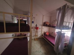 a room with two bunk beds and a window at TantraLoka Retreat Centre in Arambol