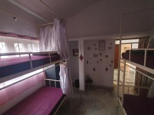 a room with two bunk beds and a hallway at TantraLoka Retreat Centre in Arambol