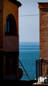 a view of the ocean from the balcony of a building at Koru House Torvaianica in Torvaianica