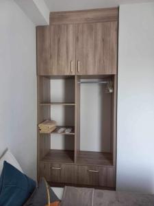 a wooden cabinet in a room with a bed at 6F Balcony View Studio Mesatierra Garden Residences in Davao City