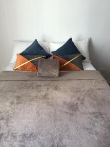 a bed with four pillows on top of it at 6F Balcony View Studio Mesatierra Garden Residences in Davao City +46 photos