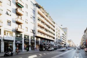 a city street with buildings and cars on the road at Splendid house Buenos Aires Piazza Lima in Milan