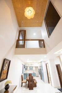 a dining room with a table and a ceiling at Family&PetFriendly 5BHK With Jacuzzi @BanjaraHills in Hyderabad