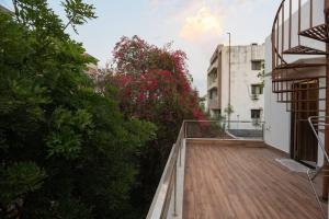 a balcony with a wooden walkway next to a building at Family&PetFriendly 5BHK With Jacuzzi @BanjaraHills in Hyderabad