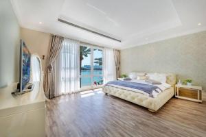 a bedroom with a bed and a large window at Pristine Paradise Villa In Palm Jumeirah in Dubai