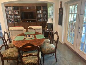 a dining room with a wooden table and chairs at Cozy House 3 large bedrooms 3full bath and king beds in West Palm Beach