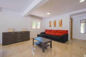 a living room with a couch and a table at Villa Bernia - PlusHolidays in Moraira