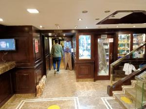 a woman walking down a hallway in a store at مركب ريفر River Boat in Cairo +82 photos