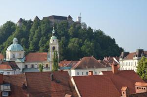 a group of buildings with a mountain in the background at i Design 9 in Ljubljana