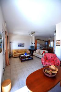 a living room with a couch and a table at Balcony of the Ionian Sea in Paralia Kanaliou