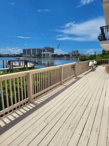 a wooden deck with a view of the water at Vanderbilt Beach 3br/3ba condo in Naples