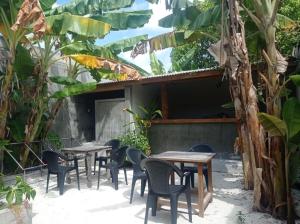 a row of tables and chairs in a courtyard at Suffix Retreat in Fuvahmulah