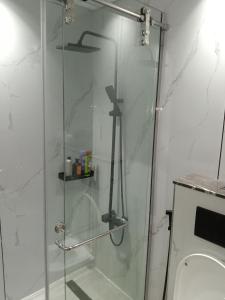 a glass shower in a bathroom with a toilet at Huge Entire apartment for Couples ,families & Groups -up to 5 Guests- with free pool, steam & Sauna ,JVC,Dubai in Dubai