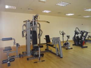a gym with several tread machines in a room at Huge Entire apartment for Couples ,families & Groups -up to 5 Guests- with free pool, steam & Sauna ,JVC,Dubai in Dubai