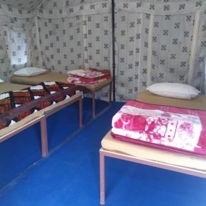 a room with two beds in a tent at Valley view camps &cottages in Nainital