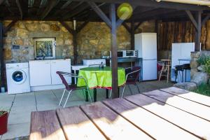 a patio with a table and chairs and a kitchen at L'Armourier in Largentière