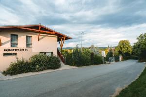 a building on the side of a road at Apartmán A5 pro 3 osoby - Monínec - celoročně in Moninec