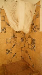 a bathroom with a shower with a shower curtain at El Higuerón (Serranía de Ronda) in Jimera de Líbar