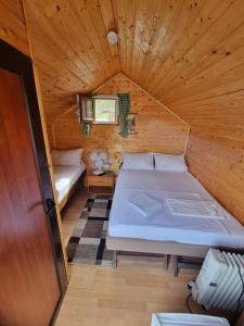 a bedroom with a bed in a wooden cabin at Livari Viewpoint in Livari
