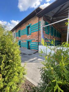 a brick building with blue and green stripes on it at Капсульний готель Добрий sleep&eat in Dnipro