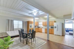 a kitchen and dining room with a table and chairs at Galveston Vacation Rental - Walk to the Beach! in Galveston