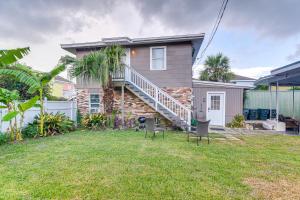 a house with two chairs in the yard at Galveston Vacation Rental - Walk to the Beach! in Galveston