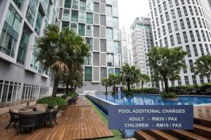 a swimming pool in a building with tall buildings at Soho Suites KLCC by Minsha in Kuala Lumpur