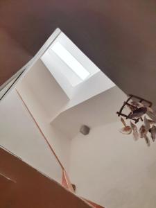 a skylight in the ceiling of a room at La Casa Rosada Arbus in Arbus +10 photos