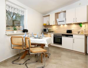 a kitchen with a table and chairs in a room at Ferienwohnung Erika in Gollwitz