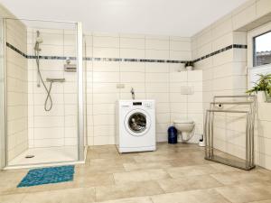 a bathroom with a washing machine and a toilet at Ferienwohnung Erika in Gollwitz +17 photos