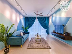 a living room with blue walls and a blue couch at Medini Signature by JBcity Home in Nusajaya