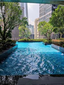 a pool of blue water in a city at 8 Kia Peng Suites KLCC by Luna in Kuala Lumpur