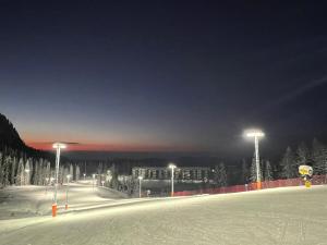 a ski slope at night with snow and lights at Snjezna Dolina Resort - Jahorina in Jahorina