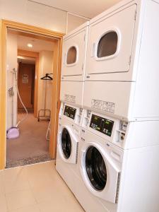 two washing machines stacked up in a laundry room at Holiday Inn Express Beijing Dongzhimen, an IHG Hotel in Beijing