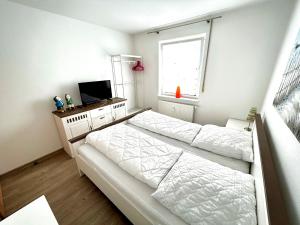 a bedroom with two beds and a window at Birkenstraße 7 Whg 1 in Zingst