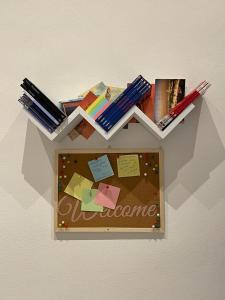 een plank met boeken en papieren aan de muur bij Franco's Home in Florence