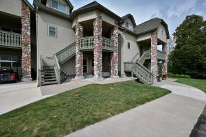 a large house with a large porch and columns at Unit 109 2 BDRM 2 BA condo in Birchwood