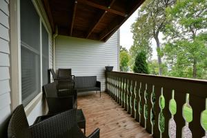 a porch with chairs and a bench on a house at Unit 109 2 BDRM 2 BA condo in Birchwood