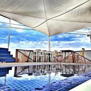 a pool with chairs and tables on a building at Aewol Torini in Jeju