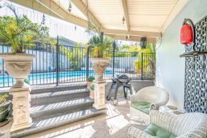 a patio with stairs and chairs and a fence at 3BR Family Oasis: Pool, BBQ, Central Gold Coast Fun! in Gold Coast
