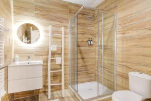 a bathroom with a shower and a toilet and a sink at Casalova07 Logements Safari Parc Bord du Rhône in Serrières +30 photos