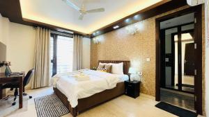 a bedroom with a bed and a desk and a window at Olive Serviced Apartments - Defence Colony in New Delhi