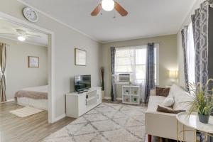 a living room with a couch and a tv at about 1 Mi to the Strand Central Unit in Galveston! in Galveston