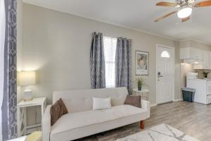 a living room with a white couch and a kitchen at about 1 Mi to the Strand Central Unit in Galveston! in Galveston