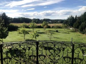 a view of a field from an iron fence at Haus Im Grnen House in the green in Neuzelle +2 photos