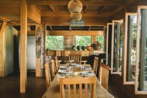 a dining room with a wooden table and chairs at Favela Mentawai in Tuapejat +22 photos