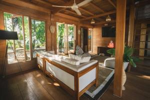 a living room with a couch and a tv at Favela Mentawai in Tua Pejat