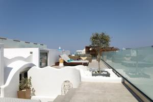 a view from the balcony of a house with white at The Museum Project Oia in Oia